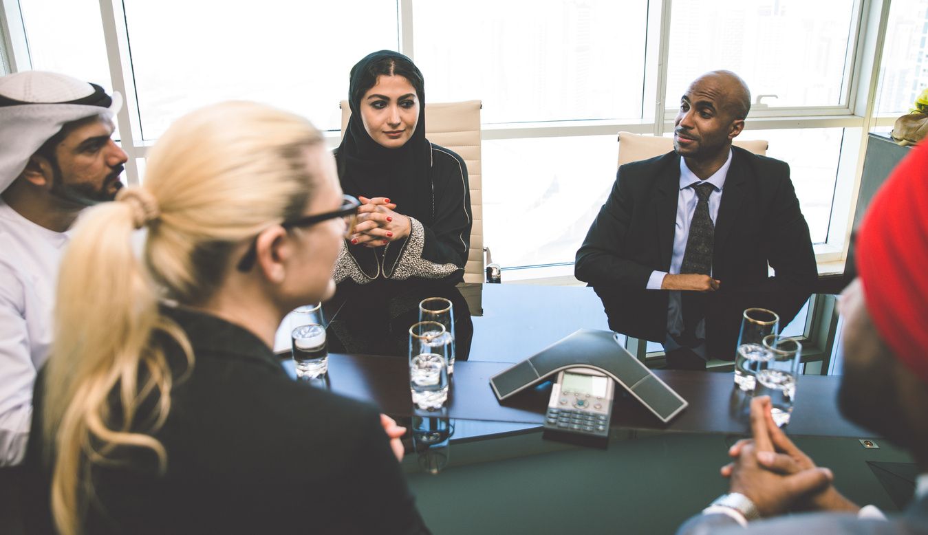 A group of people sitting around a table.